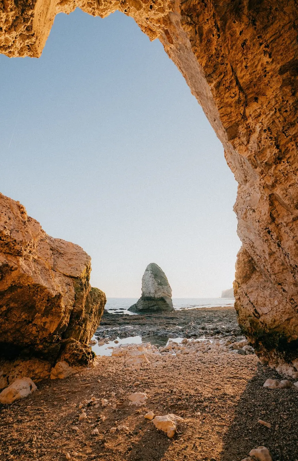 Looking out to sea through a sandstone arch on the island's coast.